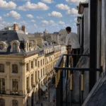 Balcony view overlooking Paris rooftops at Hotel Costes