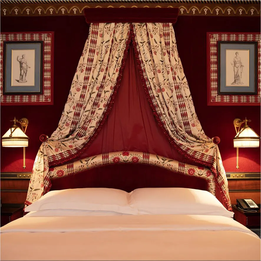 Luxurious red canopy bed in a classic Hotel Costes bedroom