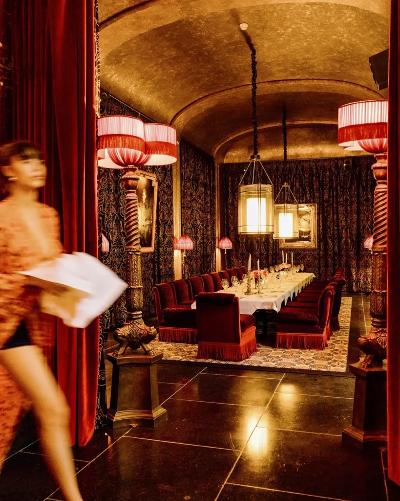Waitress serving guests inside Hotel Costes in Paris