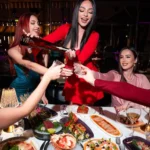 Guests celebrating with food and drinks at JustMe Milano
