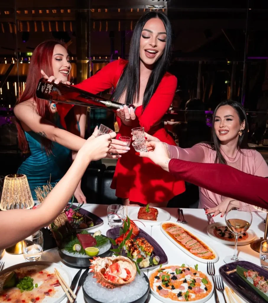 Guests celebrating with food and drinks at JustMe Milano