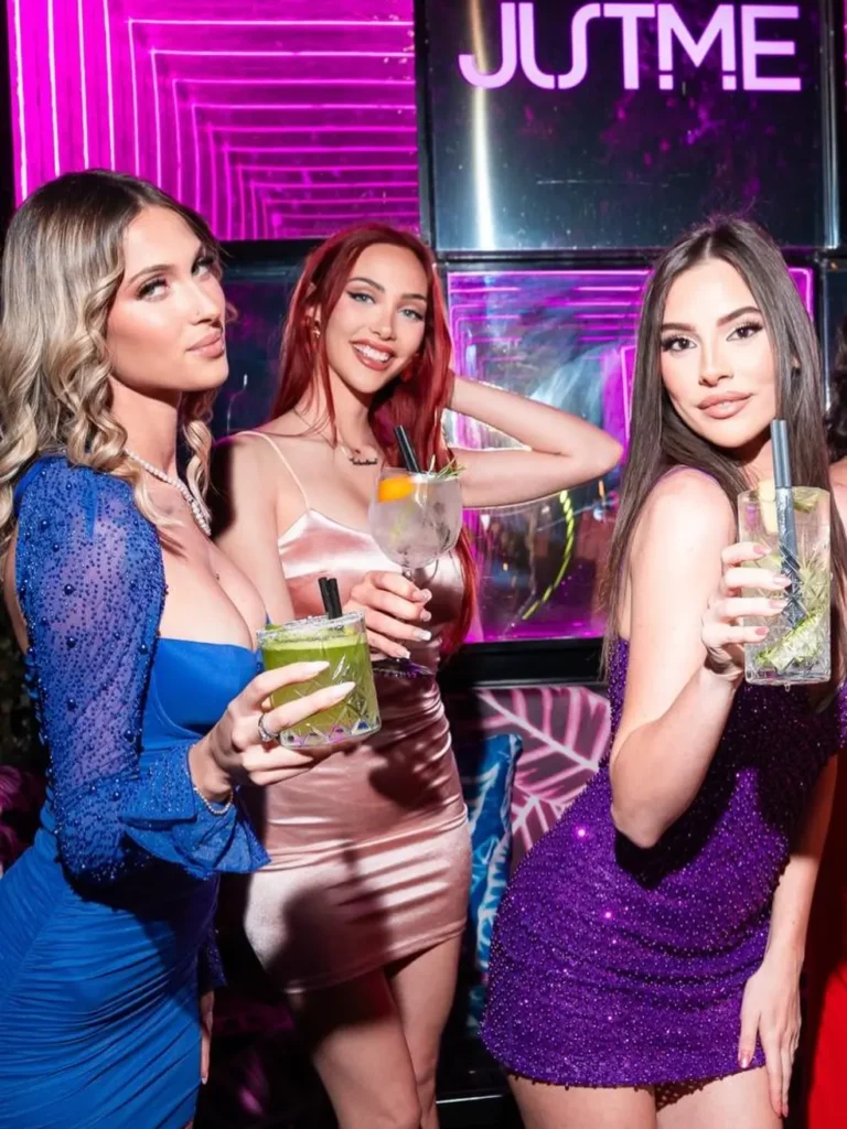 Guests posing with drinks inside JustMe Milano