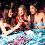 Guests enjoying drinks at an outdoor table at JustMe Milano