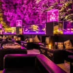 Outdoor lounge area with purple lighting at JustMe Milano