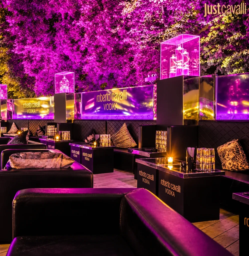 Outdoor lounge area with purple lighting at JustMe Milano