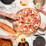 Pizza and drinks arranged on a table at JustMe Milano