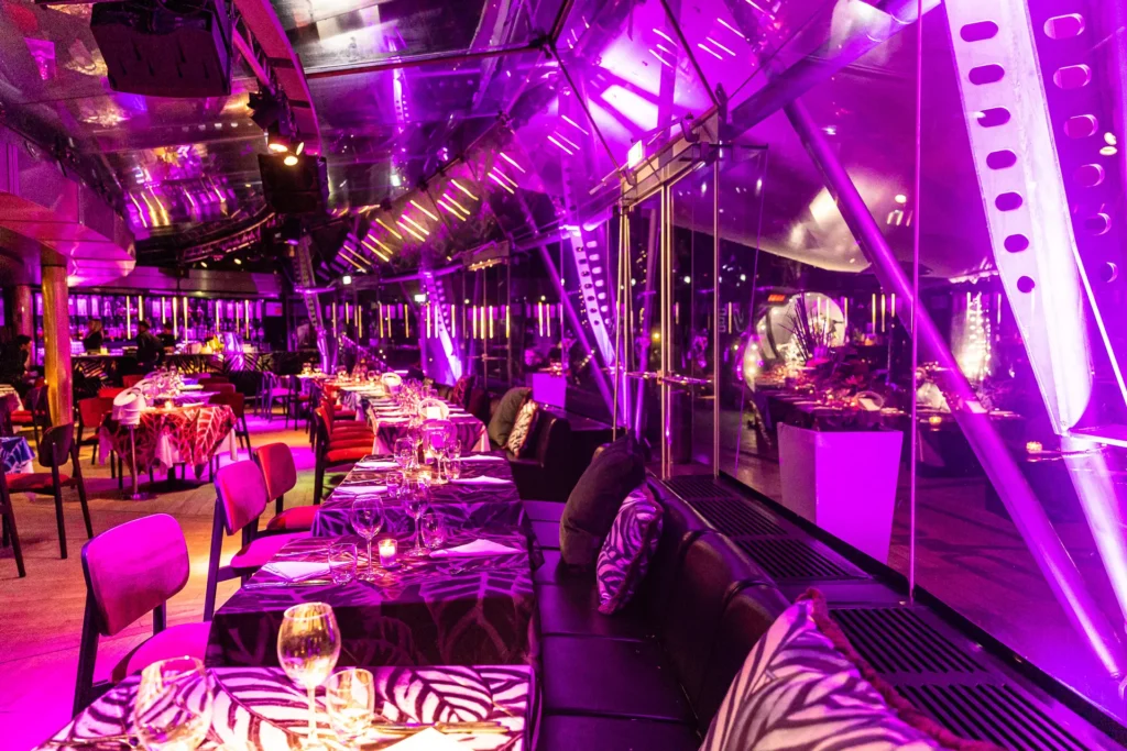 Purple-lit restaurant interior at JustMe Milano