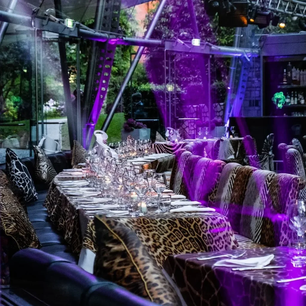 Colorful terrace dining area with purple lighting at JustMe Milano