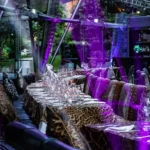 Colorful terrace dining area with purple lighting at JustMe Milano