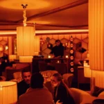 Guests dining in the warmly lit interior of Kinugawa Rive Gauche