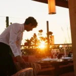 Server setting a table during sunset at Kinugawa Rive Gauche