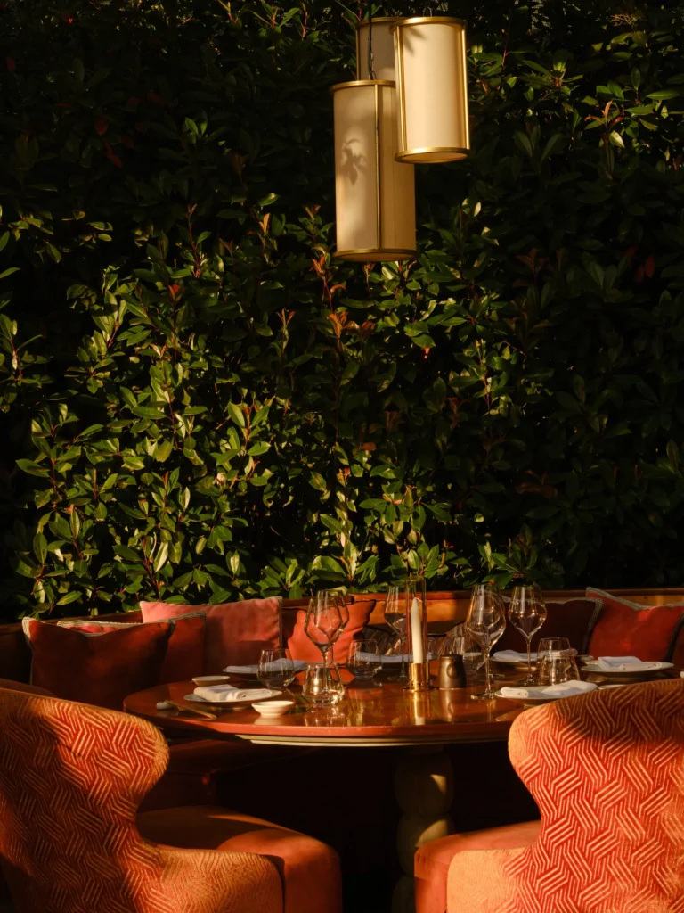 Outdoor terrace tables surrounded by greenery at Kinugawa Rive Gauche