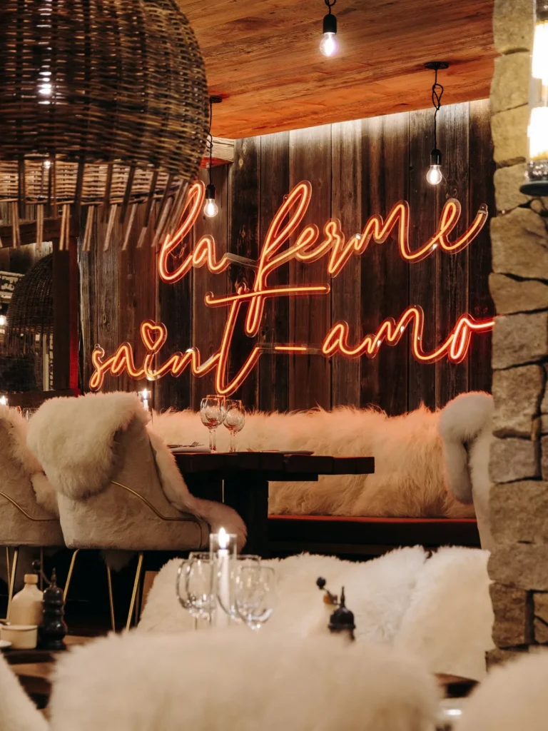 Rustic luxury dining room with a La Ferme Saint-Amour sign in Courchevel