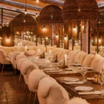 Elegant dining room with rattan pendant lights at La Ferme Saint-Amour Courchevel