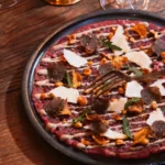 Gourmet pizza served at La Ferme Saint-Amour Courchevel