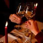 Guests raising wine glasses during dinner at La Ferme Saint-Amour Courchevel