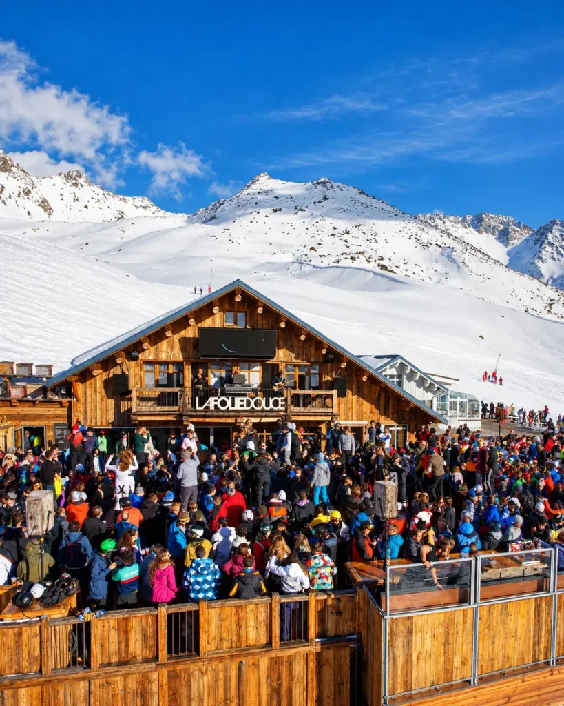 Crowd enjoying après-ski on the terrace at La Folie Douce Méribel