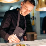Chef preparing food in the kitchen at La Folie Douce Méribel