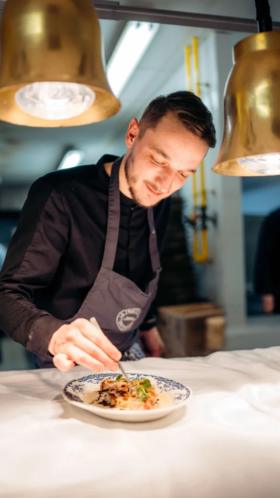 Chef preparing food in the kitchen at La Folie Douce Méribel