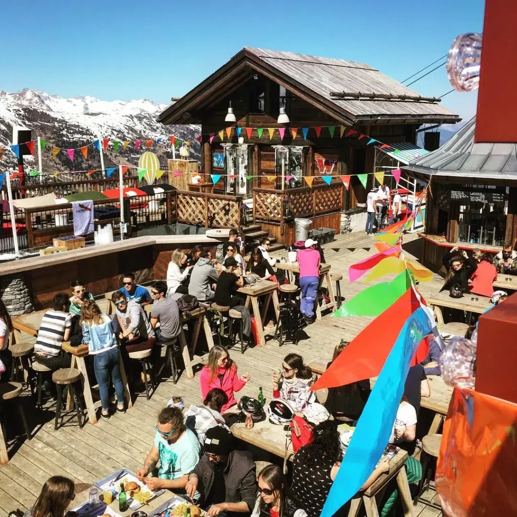Guests enjoying a lively terrace party at La Folie Douce Méribel