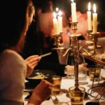 Guests enjoying a candlelit dining experience at La Mangeoire Courchevel