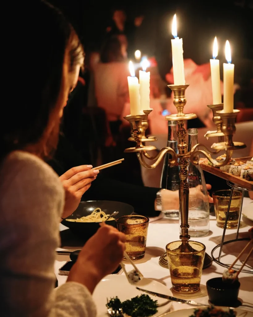 Guests enjoying a candlelit dining experience at La Mangeoire Courchevel