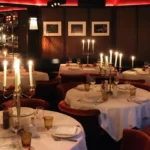 Candlelit tables in the elegant dining room at La Mangeoire Courchevel
