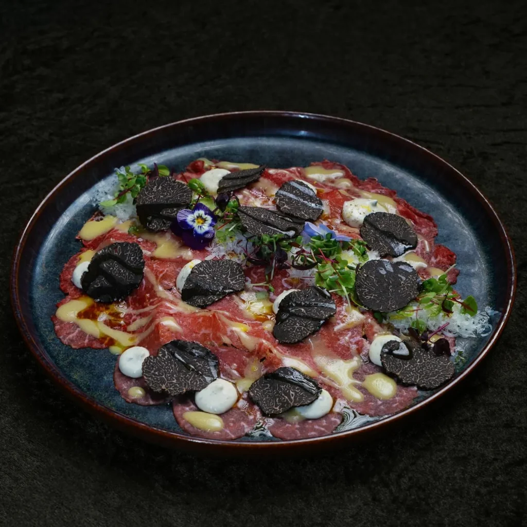Colorful gourmet dish served at La Mangeoire Courchevel