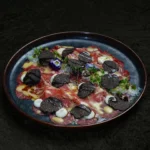 Colorful gourmet dish served at La Mangeoire Courchevel