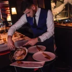 Gourmet dish being prepared and served at La Mangeoire Courchevel