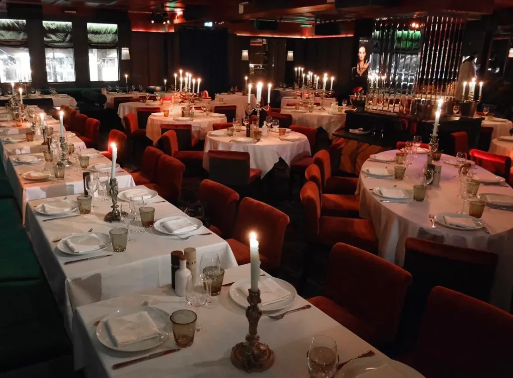 Luxurious restaurant interior with white tablecloths at La Mangeoire Courchevel