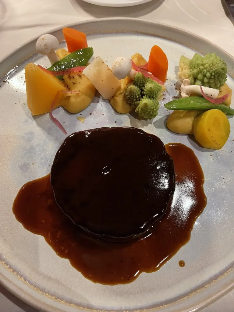 Gourmet beef dish with vegetables served at La Saulire Courchevel