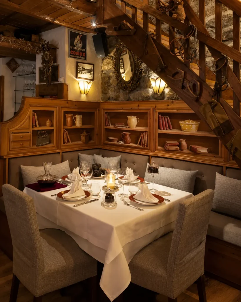 Elegant dining table and rustic wood interior at La Saulire Courchevel
