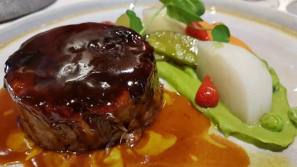 Gourmet beef dish with vegetables and sauce at La Saulire Courchevel