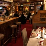 Warm wood-paneled restaurant interior at La Saulire Courchevel