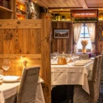 Rustic wood interior and dining tables at La Saulire Courchevel