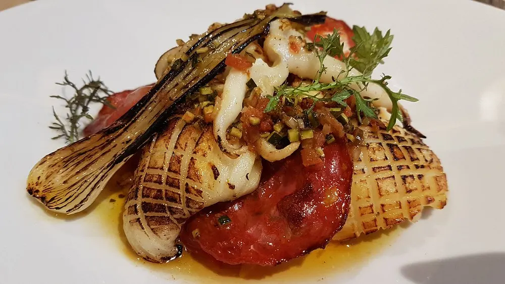 Gourmet seafood dish with vegetables served at La Saulire Courchevel