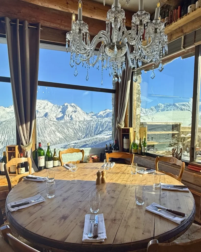 Elegant dining room with panoramic mountain views at La Soucoupe Courchevel