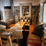 Cozy lounge seating and fireplace inside La Soucoupe Courchevel