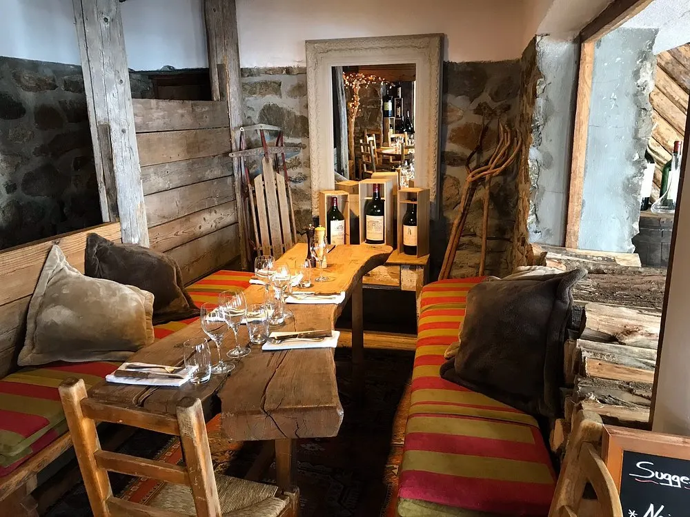 Cozy lounge seating and fireplace inside La Soucoupe Courchevel