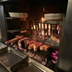 Open grill and fire cooking area at La Soucoupe Courchevel