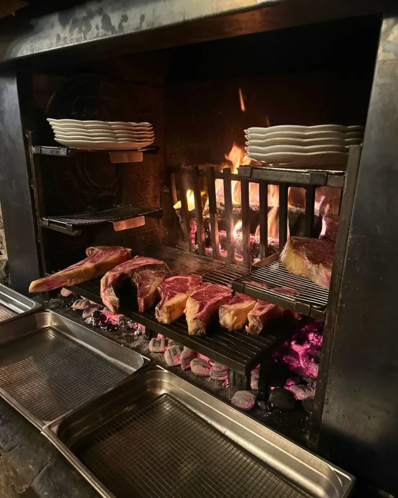 Open grill and fire cooking area at La Soucoupe Courchevel