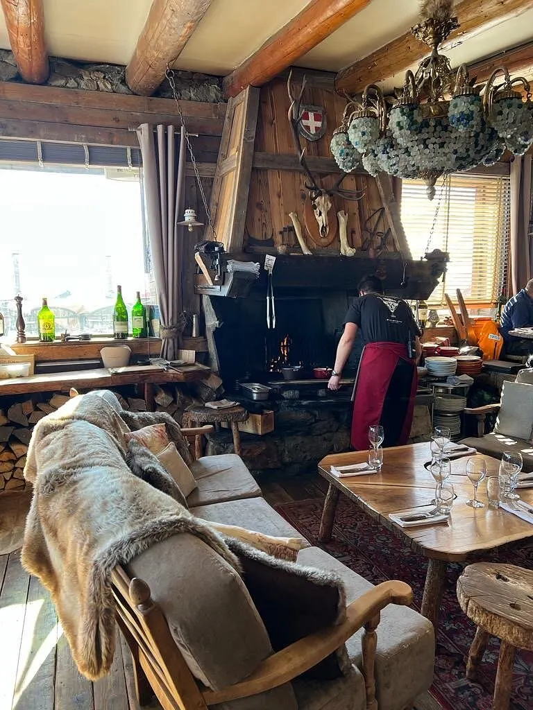 Cozy restaurant interior with alpine decor at La Soucoupe Courchevel