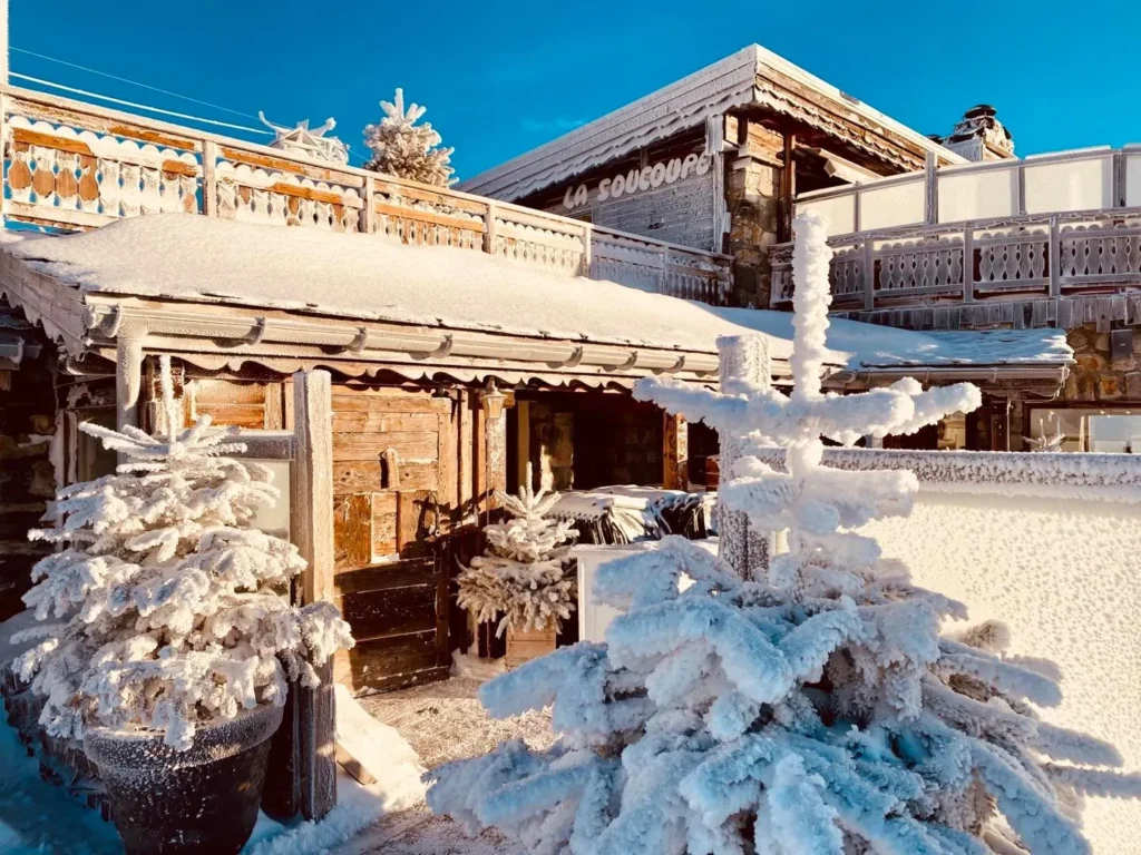 Snow-covered exterior and terrace of La Soucoupe Courchevel