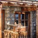 Dining table beside a panoramic window at La Soucoupe Courchevel