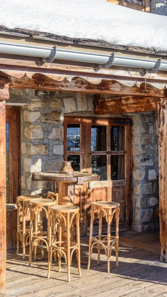 Dining table beside a panoramic window at La Soucoupe Courchevel