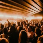 Guests dancing under warm lights at L'Arc Paris