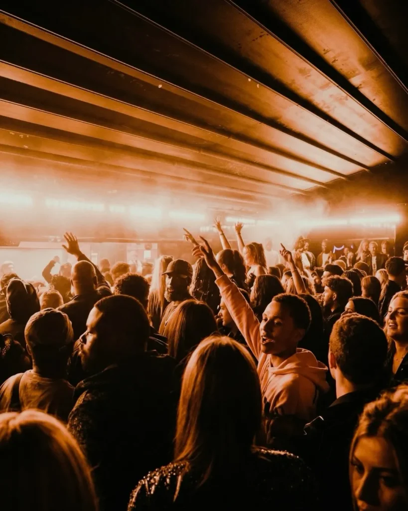 Guests dancing under warm lights at L'Arc Paris