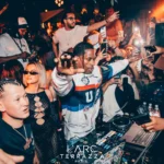 DJ performing to a crowd at L'Arc Paris
