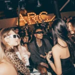 Guests enjoying the nightlife atmosphere inside L'Arc Paris